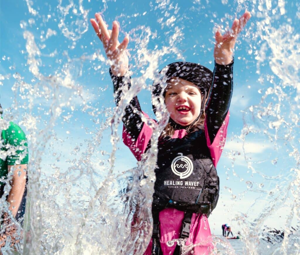 Happy child splashing water