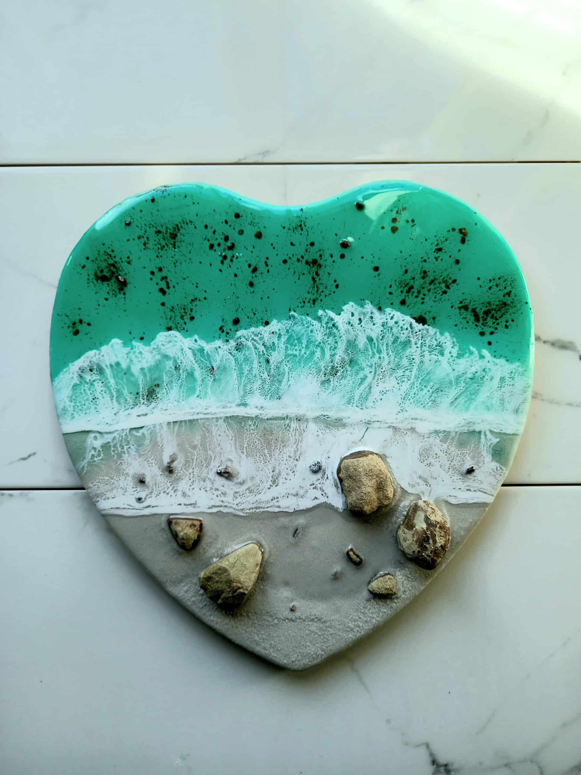 Heart-shaped, resin art piece resembling seashore.
