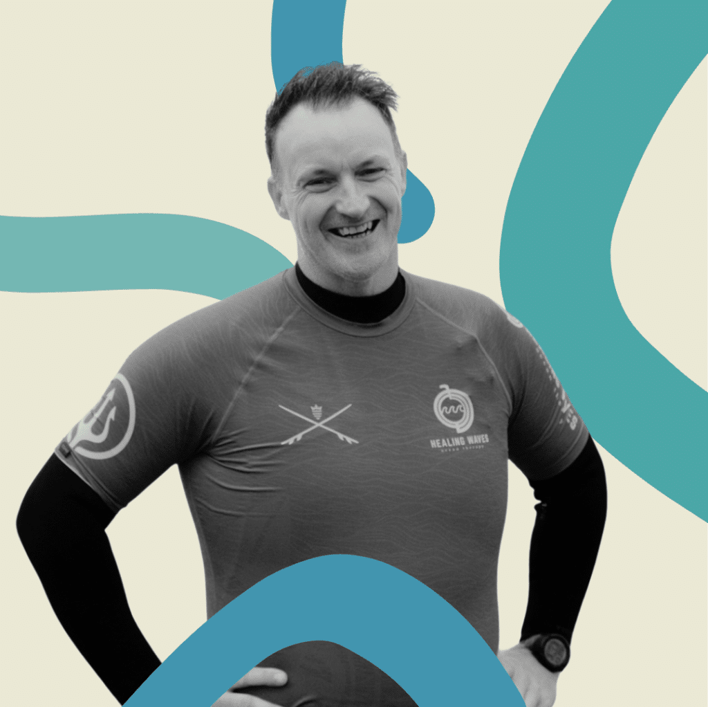 Smiling man in Healing Waves sports shirt
